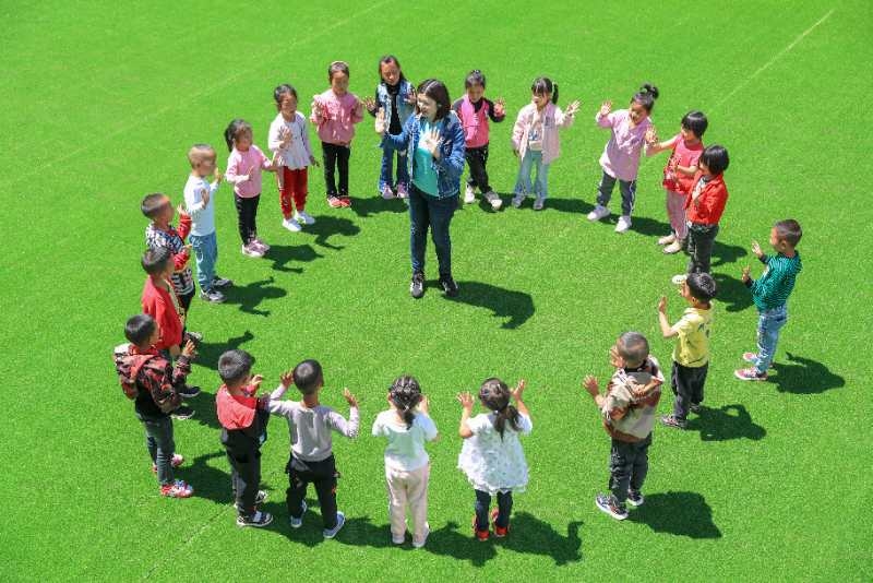 6月10日，江阳区援建的盐源县合哨幼儿园开园了！江阳区民盟基层委盟员、援彝干部何苗，开学的第一天到幼儿园和孩子们一起唱歌跳舞做游戏。.jpg